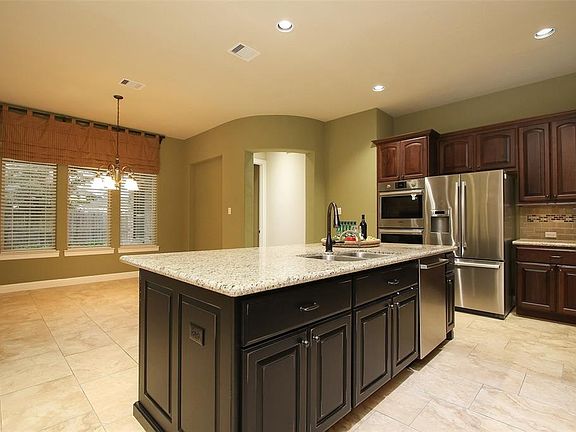 Large island is open to the sizable breakfast room with lots of natural light.