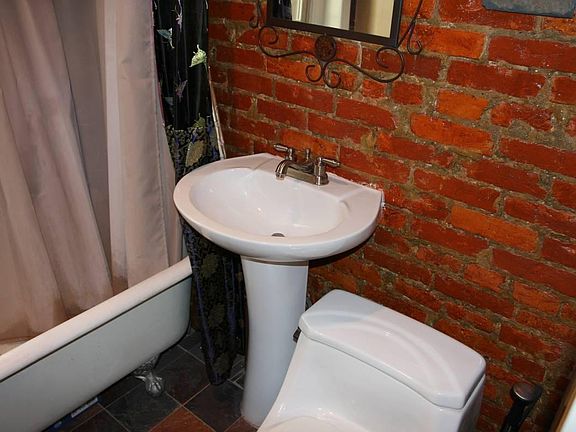 Orignal claw-foot tub. Hand-chipped Italian tile.