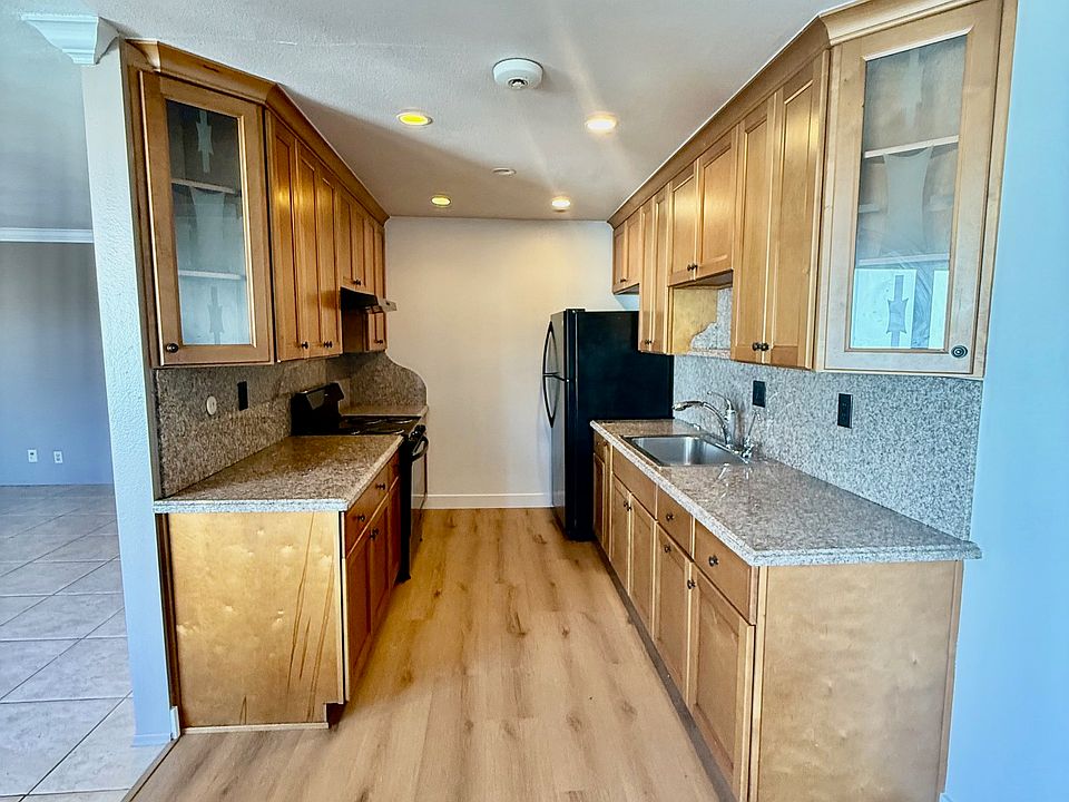 Kitchen includes new flooring, a refrigerator, and stove