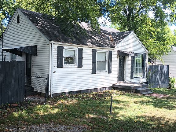 Front of house with privacy fencing.