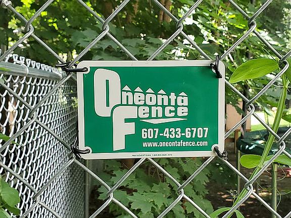 Fenced in back yard with swingset