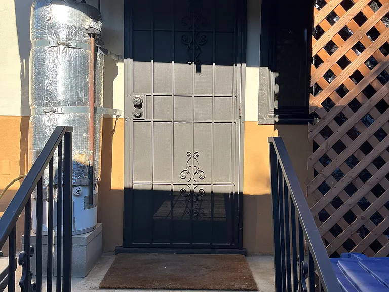 This is the back door. The washer/dryer is to the right. The new lattice will be painted soon.