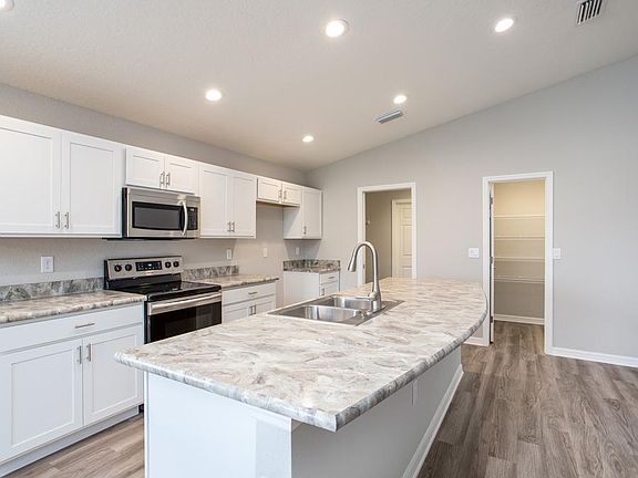 Enjoy your spacious kitchen with luxurious finishes and lots of storage - Photo showcases a home wit