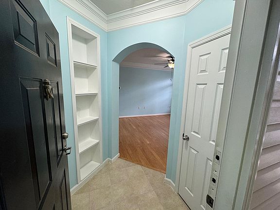 Foyer, tiled. built in book shelf, coat closet
