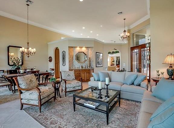 Living Room with Dry Bar neutral ceramic tile on the diagonal and fabulous entertainment area