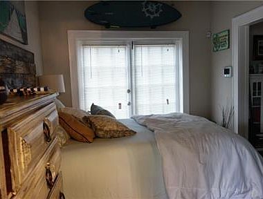 Bedroom with double French doors leading to expansive, shaded wood deck! Paradise!