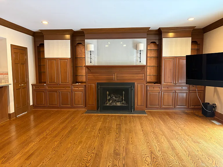 Paneled Great Room with fireplace/gas logs and extensive built-ins