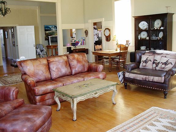 Huge great room with original wood flooring and antique molding