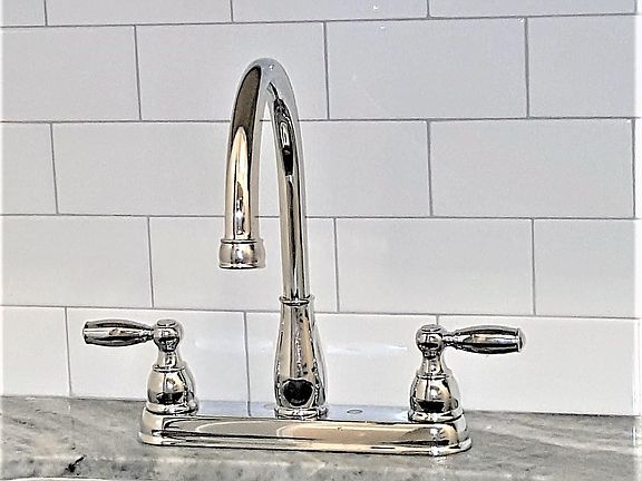 Subway tile back splash and chrome faucet