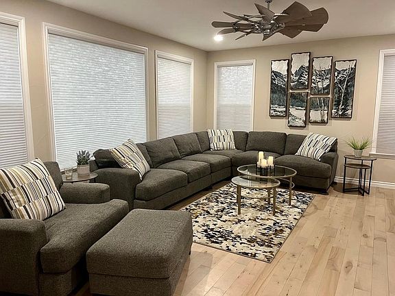 Bright, comfortable living room with maple wood floors