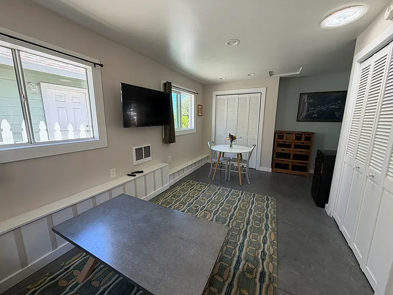 From couch, looking toward dining area. 
Two small dressers in this photo as well. 
Closet on the right is for clothes. Closet behind the dining table is for dishes/food.