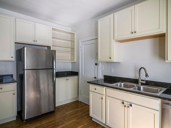 Recently renovated kitchen with new cabinets, dishwasher, refrigerator, stove, microwave and sink.
