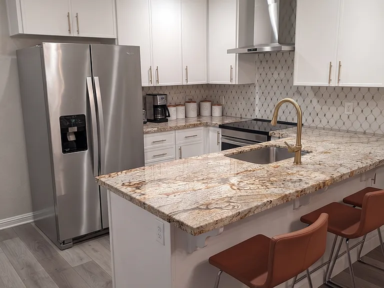 Fully-renovated kitchen with brand-new energy-star appliances, Delta hardware, brand-new 1hp garbage disposal, and granite countertops.
