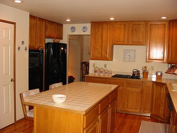 View of the kitchen from the family room. Jenn-aire stovetop offers a gas gril