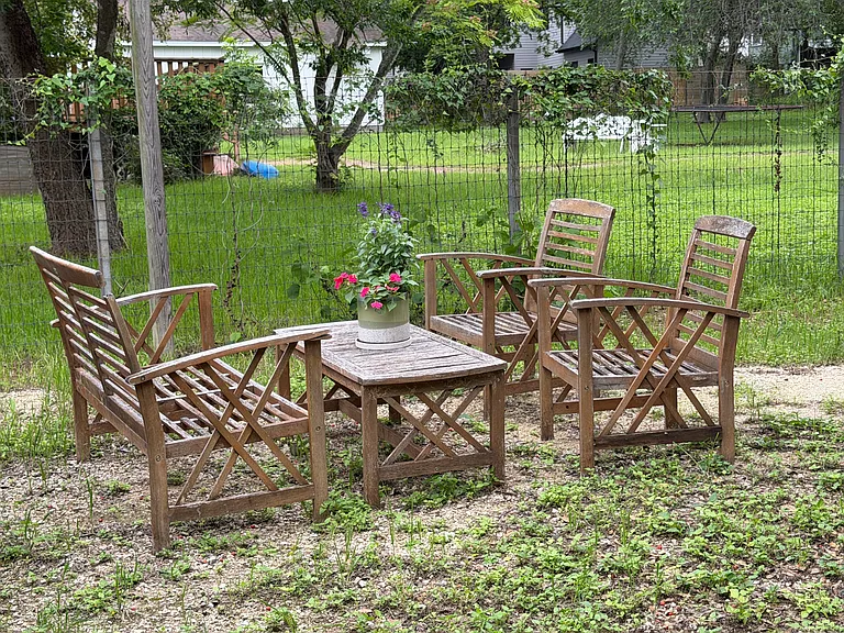 Outdoor garden seating area with beautiful green views.