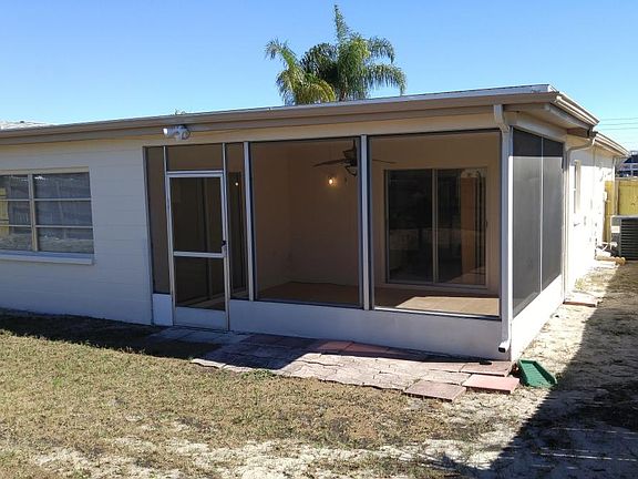 Fenced backyard with screened lanai