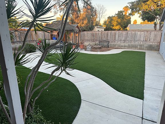 Backyard, grill, fire pit, gazebo area with patio furniture