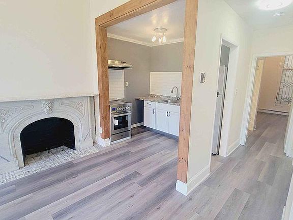 living room facing kitchen and lovely marble fireplace