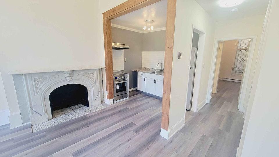 living room facing kitchen and lovely marble fireplace