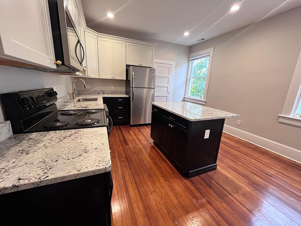 Modern and custom kitchen with soft close drawers, granite and brass fixtures.