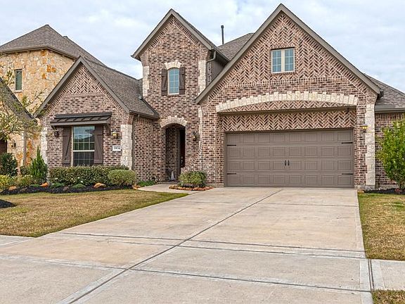 Notice the extensive use of elaborate patterns in the brick and stone work. The double paned windows, RainBird Sprinkler system in front and back yard, maturing landscape, gutters, 2 back gates, 2 16 Seer AC system and oversized 2 car garage with a 5