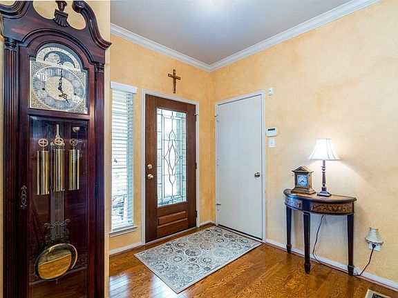 A beautiful stained leaded glass door with sidelights allows natural light to flow into the space and welcomes you to stay away!