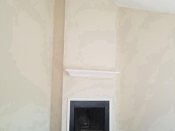 Living room with cathedral ceiling, frireplace and faux hard