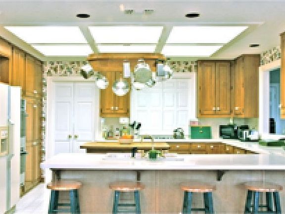 Well lite kitchen with views out the front and back of the house.