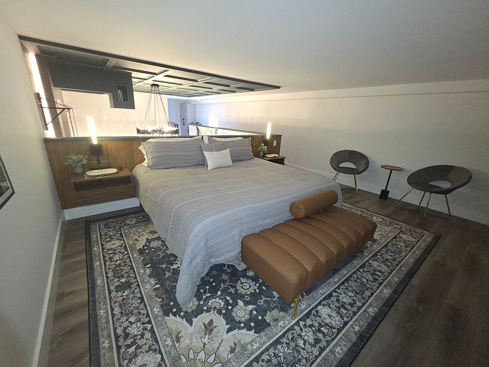 Luxurious bedroom with a queen bed, plush pillows, and designer details.