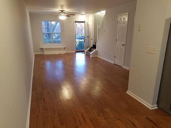 View from kitchen/sunroom through living room to front door.