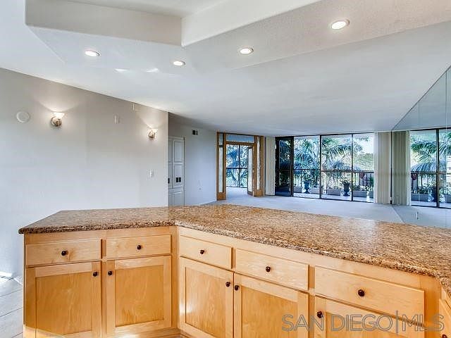 Open concept kitchen with granite counters, recessed lights