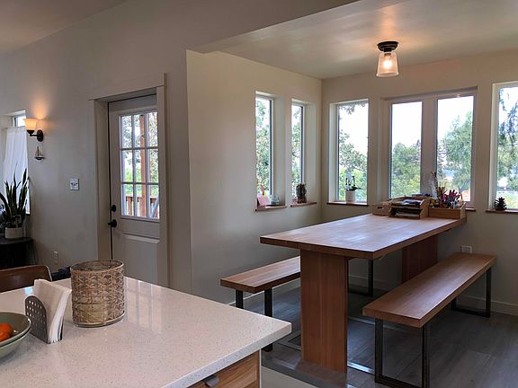 The build in dining nook comfortably seats six adults. Wrap around windows provide plenty of natural light, making this spot great for art projects.