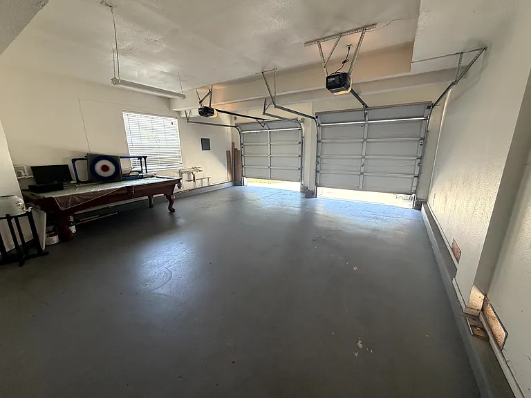 2-car garage with automatic openers and additional space for storage.