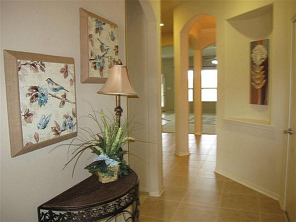 The light & bright kitchen boasts granite countertops, tile floor & backsplash, stainless steel appliances, recessed lighting & abundant 42" cabinetry!