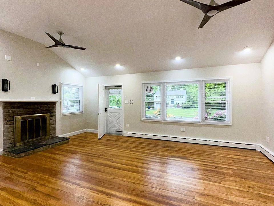 livingroom with fireplace. cathedral ceiling. livingroom opens to dining room ,kitchen and hallway to bedrooms