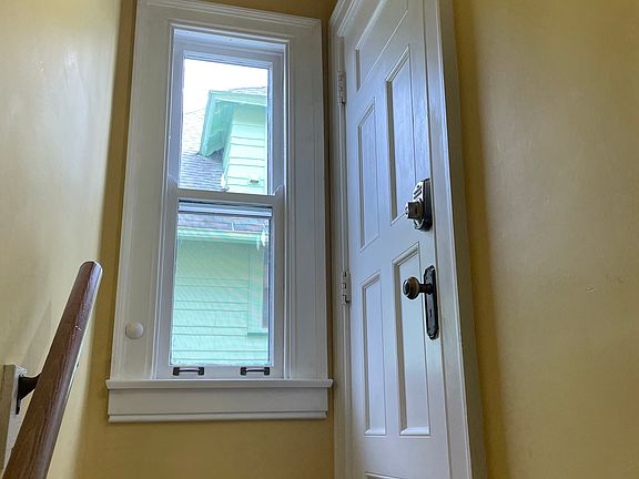 Second stair landing with keypad door into apartment.
