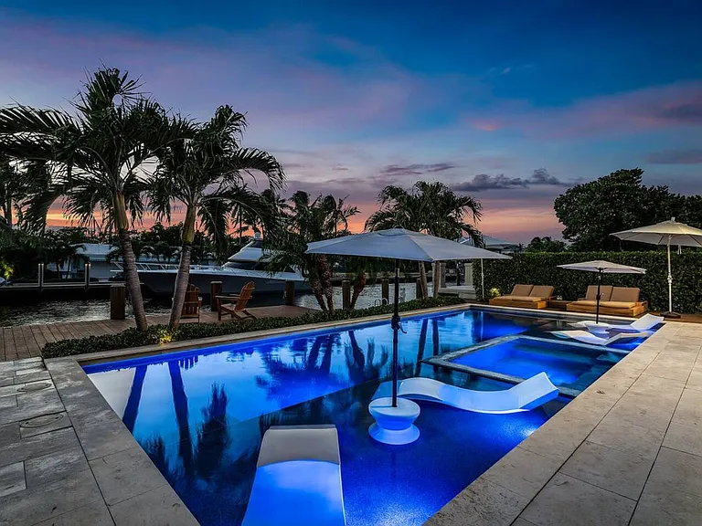 Evenings by the pool are pure magic, with serene lighting and tropical palms.