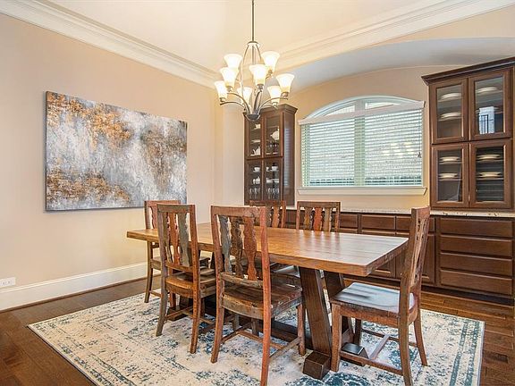 Formal dining room boasts crown molding and amazing built-ins that match the kitchen cabinetry