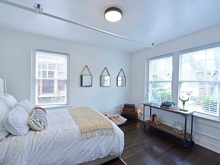 Bedroom with hardwood-style flooring