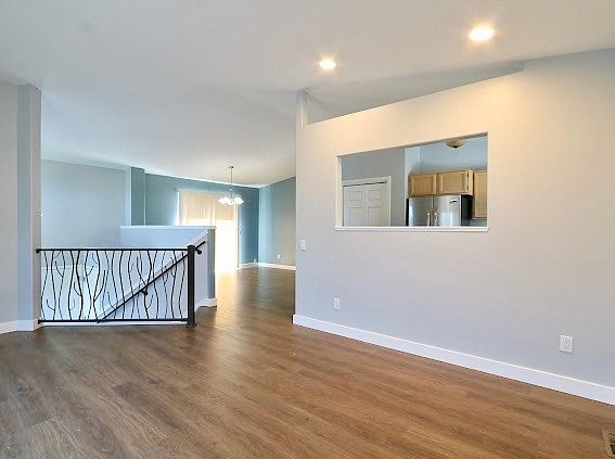 From living room looking past entry way stairs and into the dining room