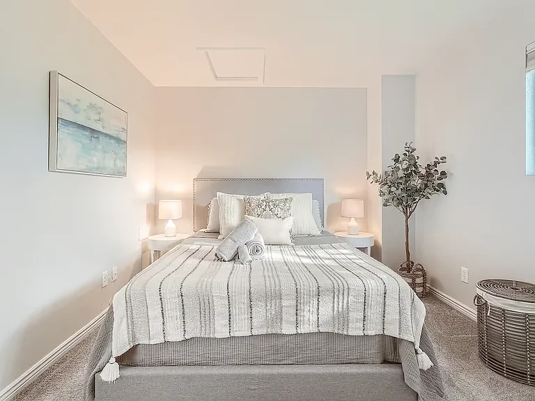 A bright and serene retreat with soft textures, layered pillows, and gentle lighting_perfect for a peaceful night's sleep or a cozy midday nap.
