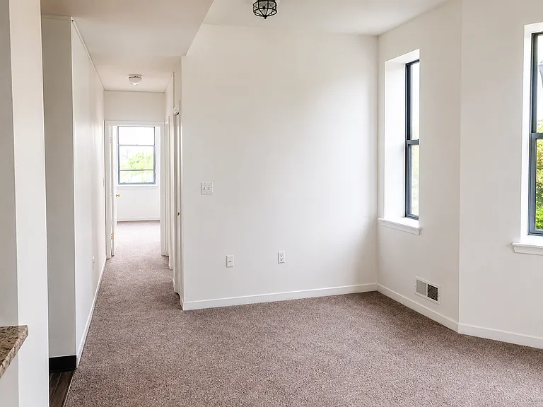 Left side of living room area & hall to bedroom