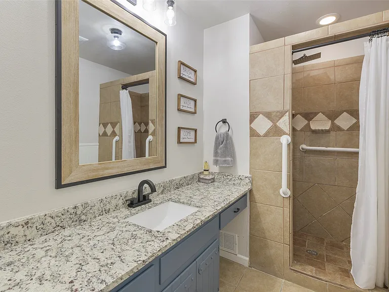 Bathroom vanity with granite-style countertop and undermount sink