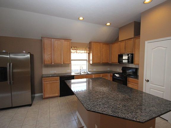 The kitchen is the focal point of the home. Refrigerator, wa