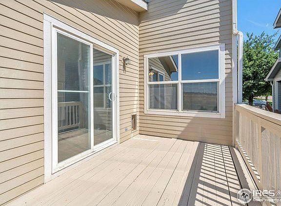 Freshly painted deck with sliding glass door and doggy door.