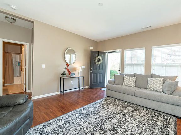 Living room view. From the living room, you can see the hallway into the first full bathroom, and two guest bedrooms.