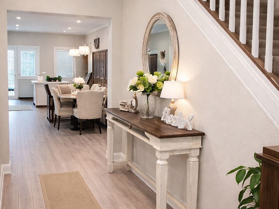 Welcoming entry with high ceilings, natural light, and open sightlines into the main living space.
