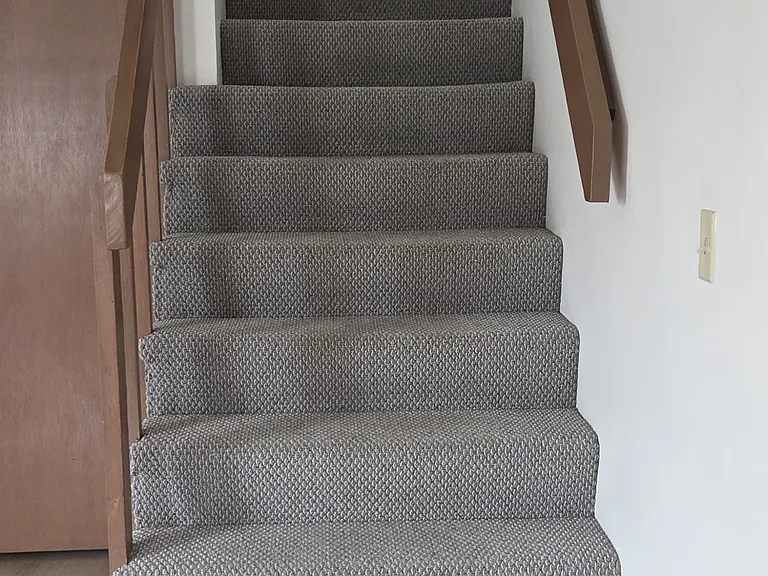 Stairs to 2 bedrooms on 2nd floor.