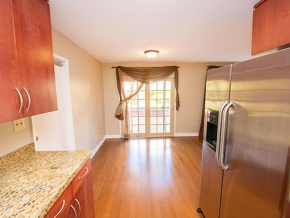 The long galley kitchen greets you on the left side as you walk through the front door entryway (new tile floor not pictured).