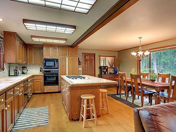 The adjacent kitchen is sure to be a favorite hang-out for everyone with its o